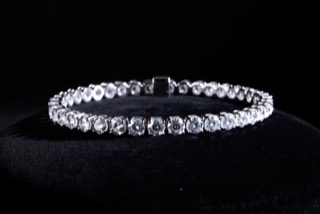A line bracelet set with stones.