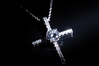 A cross pendant on a chain.