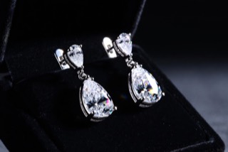 A pair of drop earrings in a box.