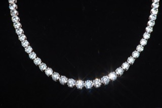 A necklace photographed against a dark ground.