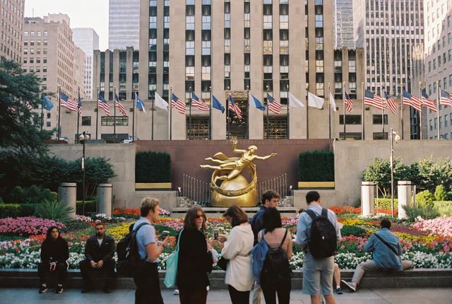 4:50 PM • Rockefeller Center — Channel Gardens Glow: People pause to admire the flowers and golden Prometheus statue bathed in warm late afternoon light.